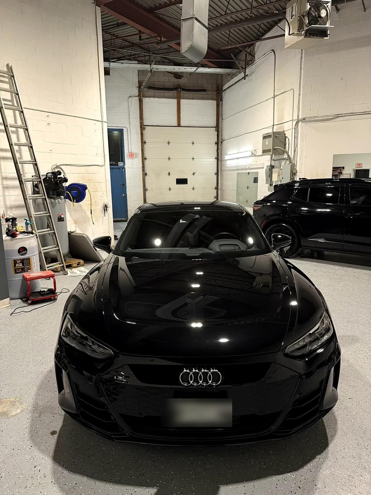 Black Audi e-tron GT with a flawless gloss finish at Cosmo Car Customs