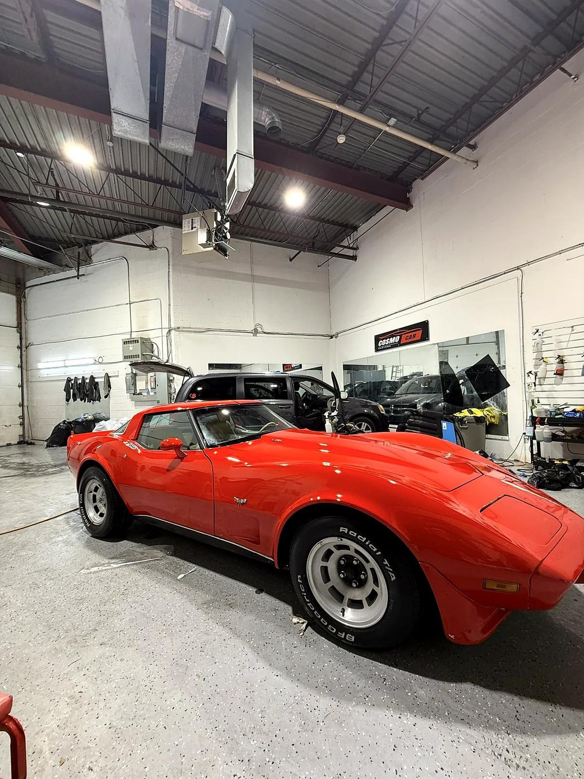 Classic red Chevrolet Corvette being detailed at Cosmo Car Customs