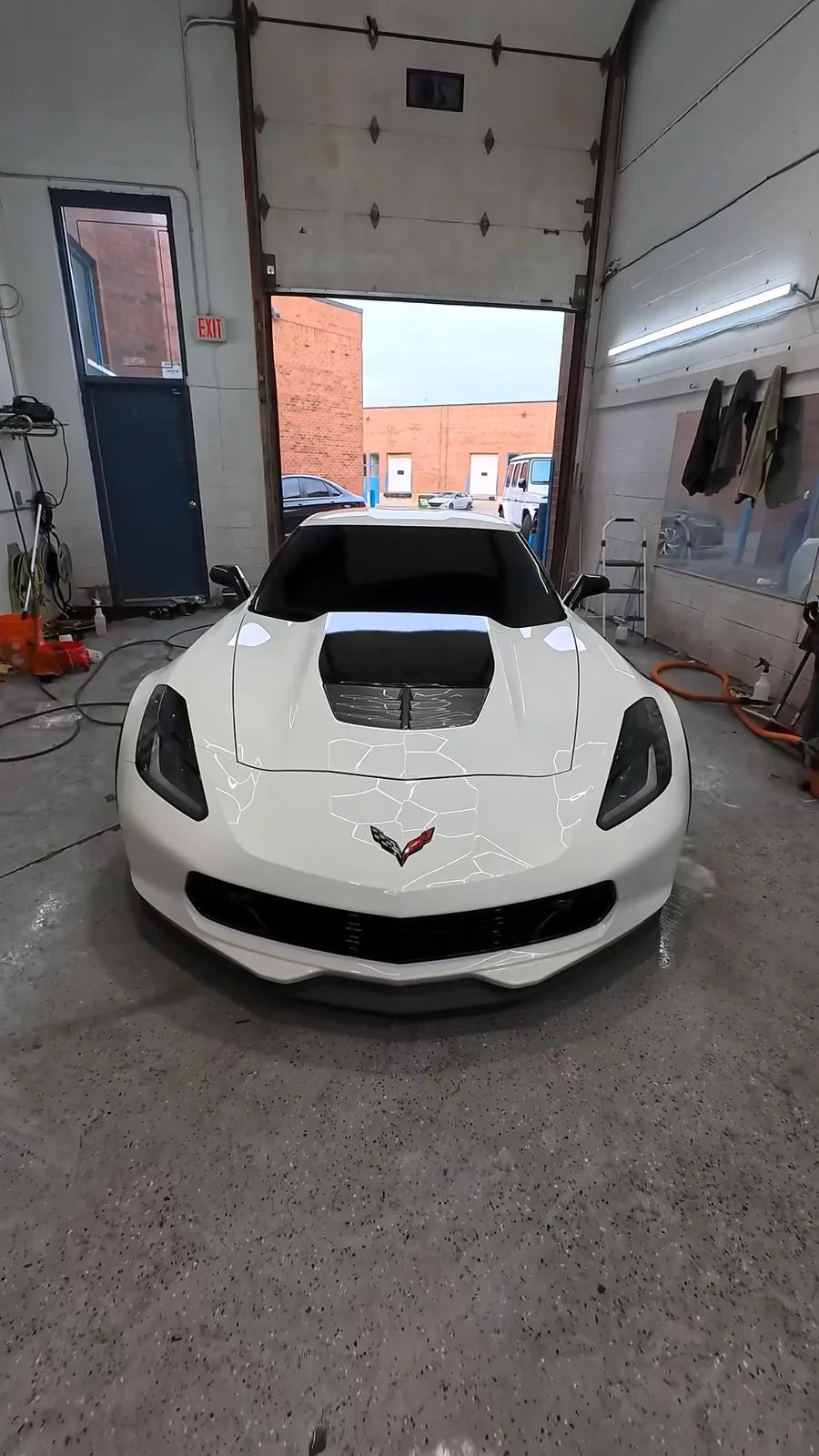 White Chevrolet Corvette in the Cosmo Car Customs detailing bay