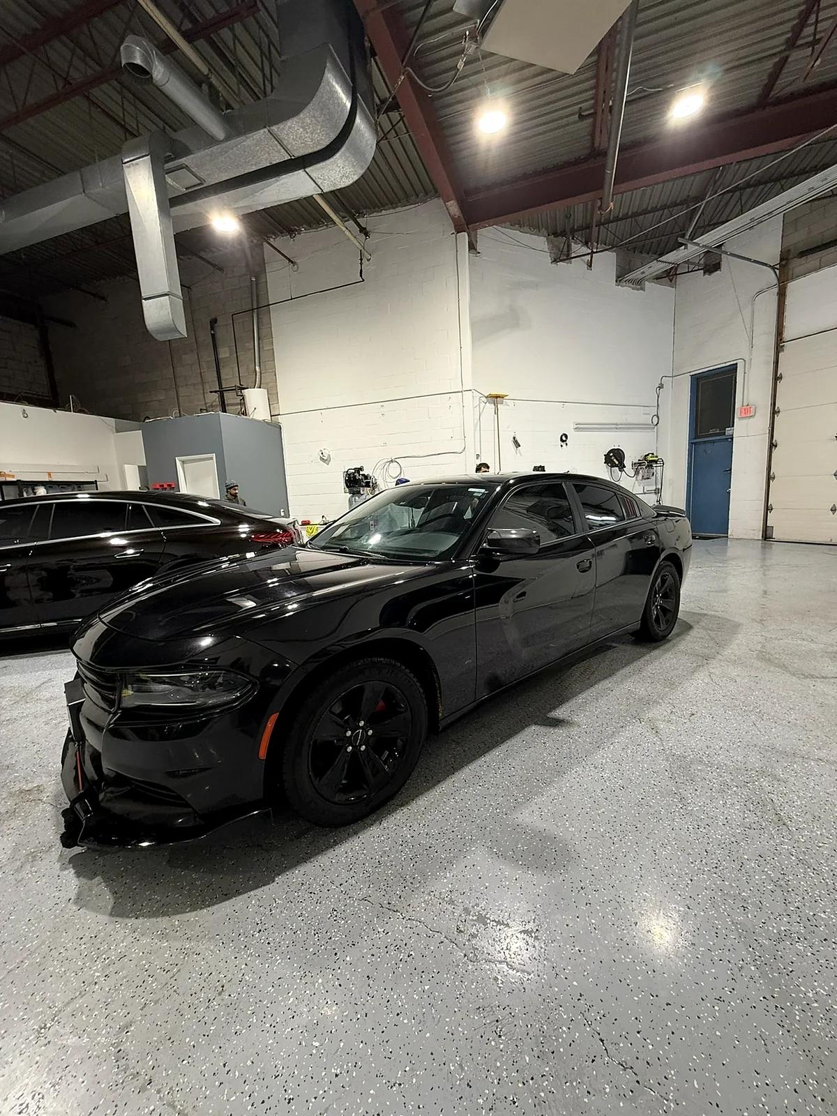 Black Dodge Charger with a deep gloss finish at Cosmo Car Customs Mississauga