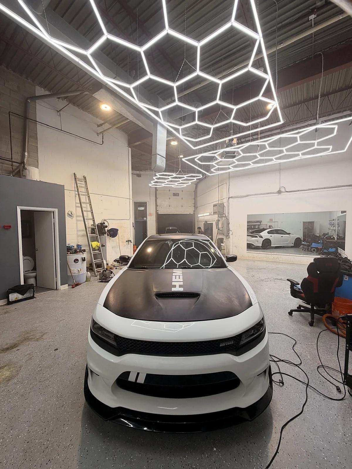 White Dodge Charger with a carbon fibre hood at Cosmo Car Customs Mississauga