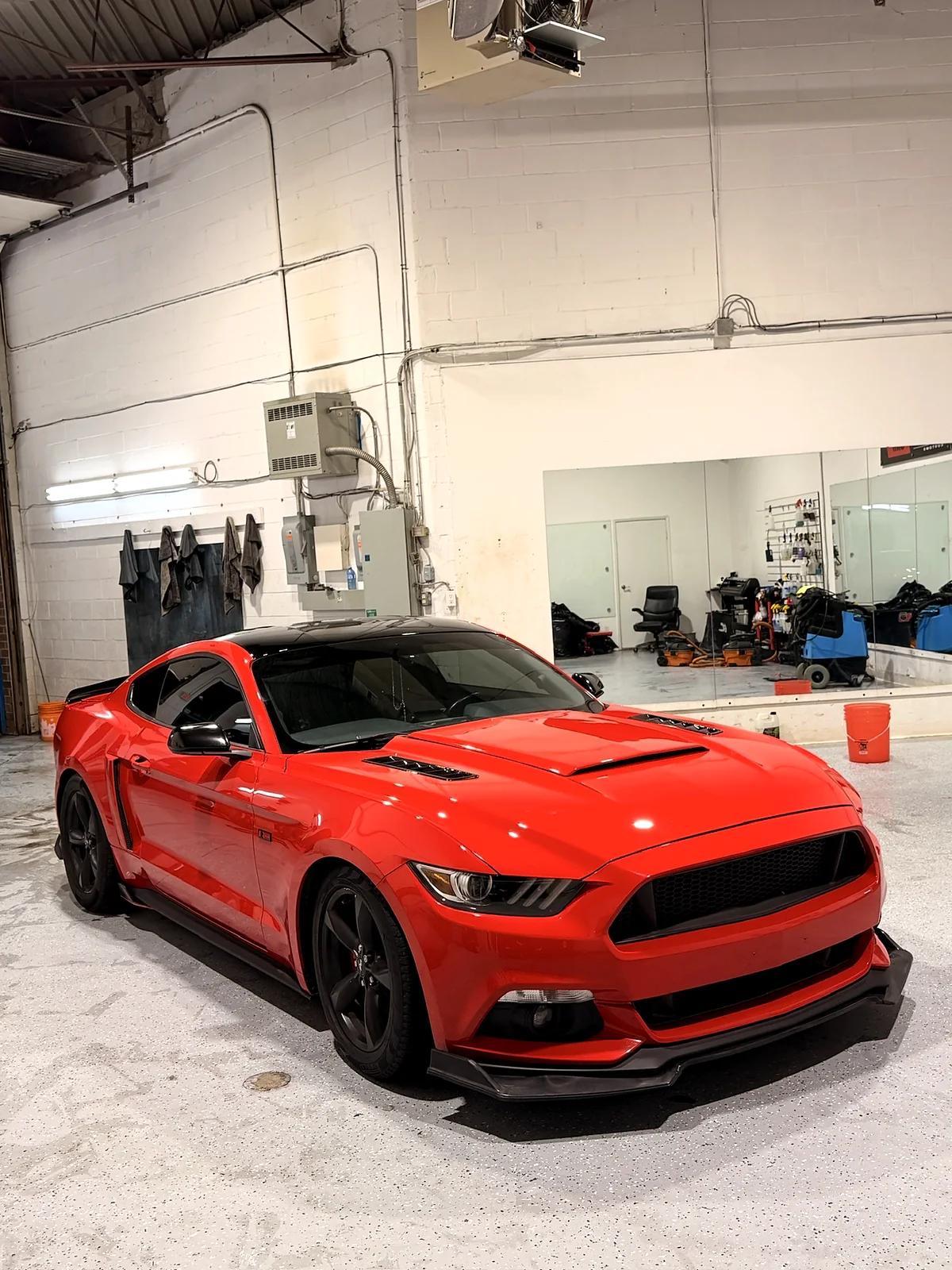 Red Ford Mustang in the Cosmo Car Customs detailing studio