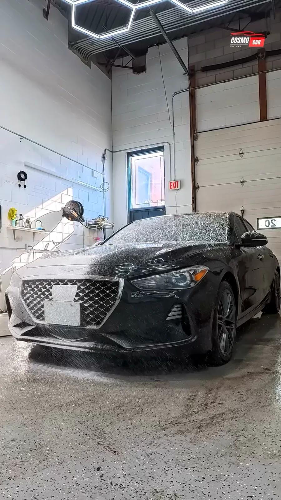Genesis G70 covered in snow foam during a full exterior decontamination wash