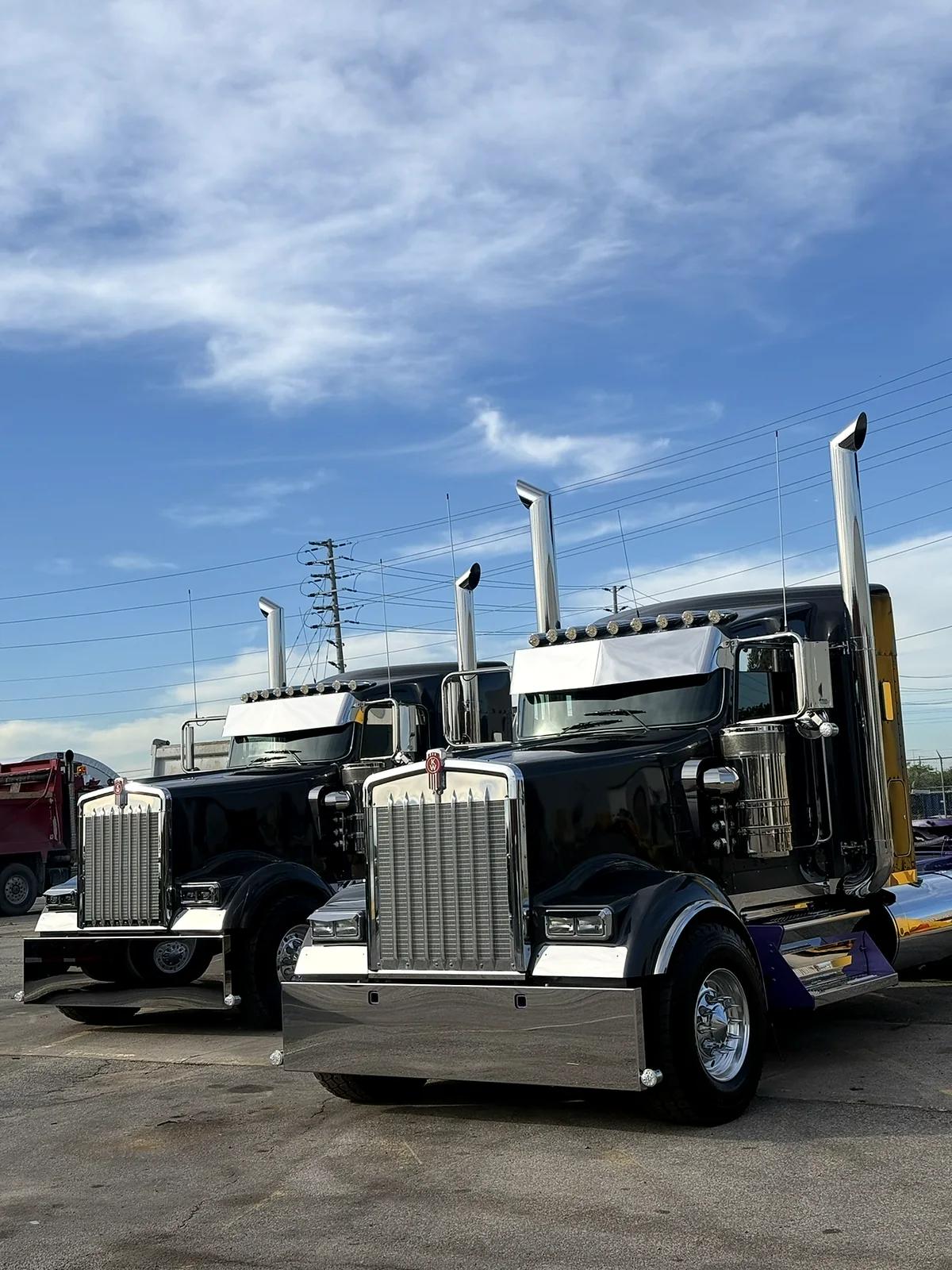 Two detailed Kenworth trucks with polished chrome outside the Mississauga shop