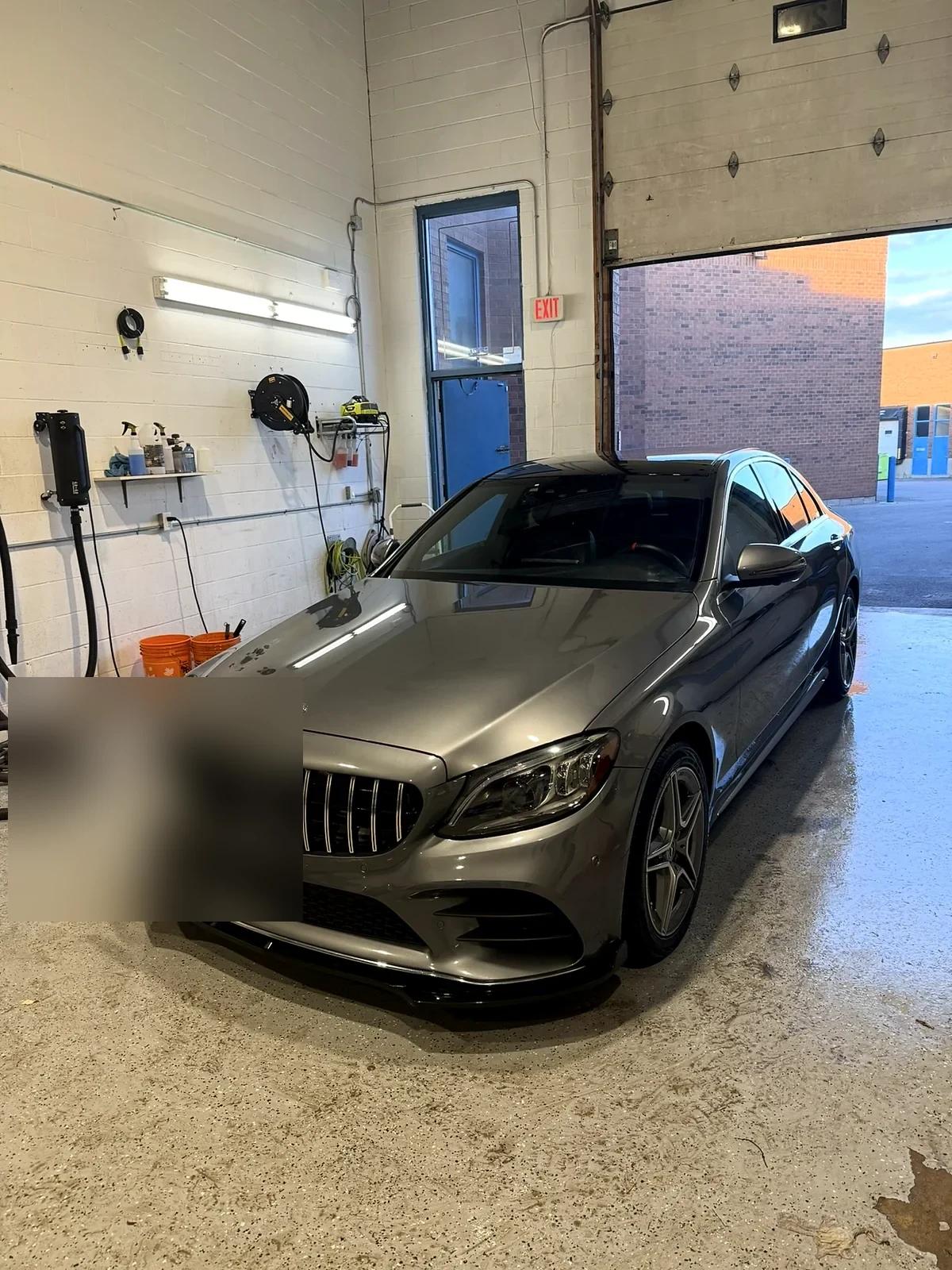 Bronze Mercedes-AMG C-Class in the Cosmo Car Customs detailing bay