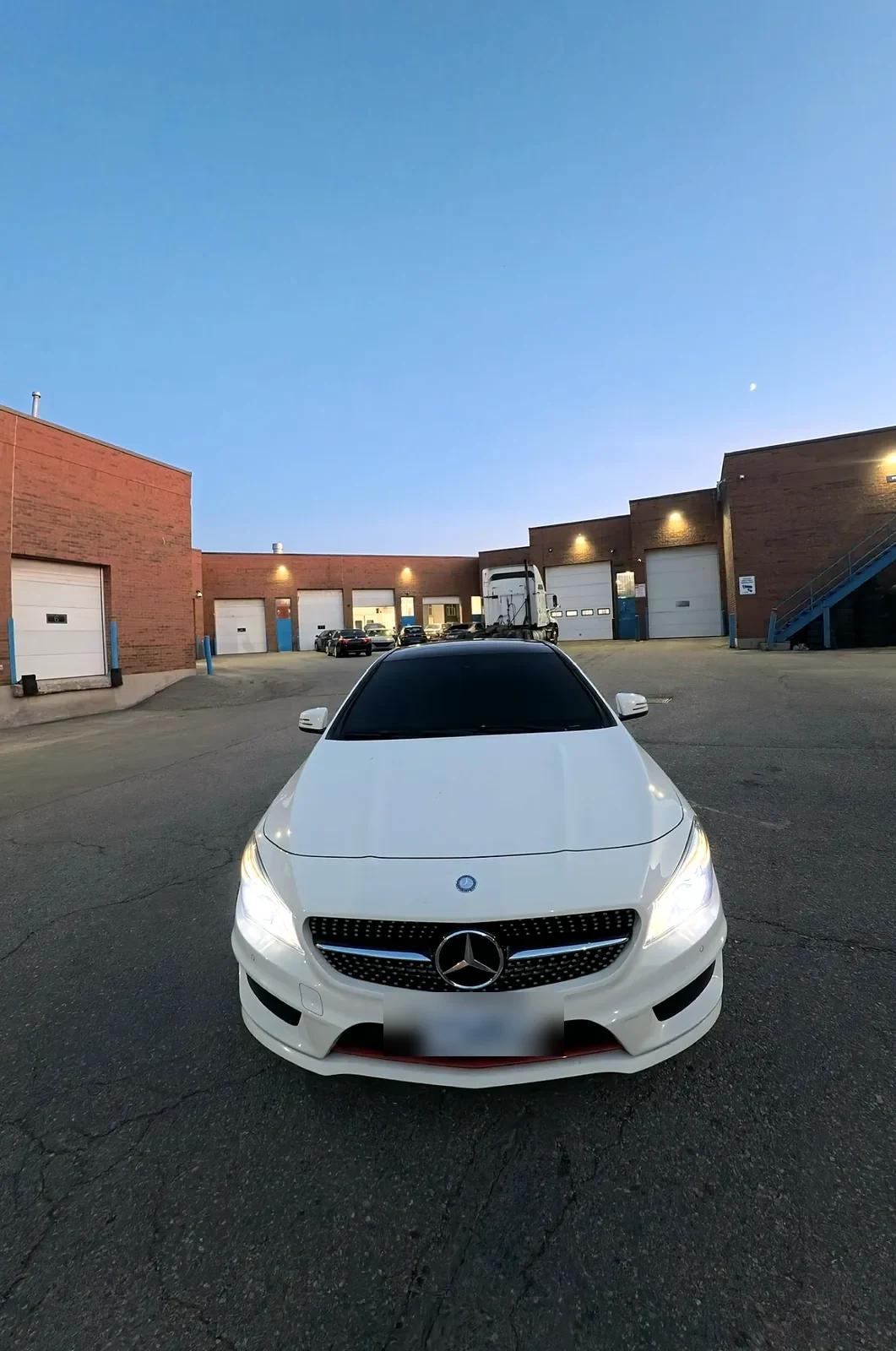 White Mercedes-Benz CLA after a full detail outside the Cosmo Car Customs shop