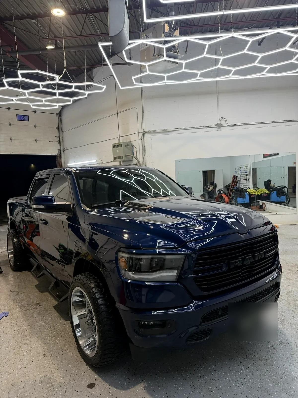 Dark blue Ram 1500 pickup with a deep gloss finish in the Mississauga studio