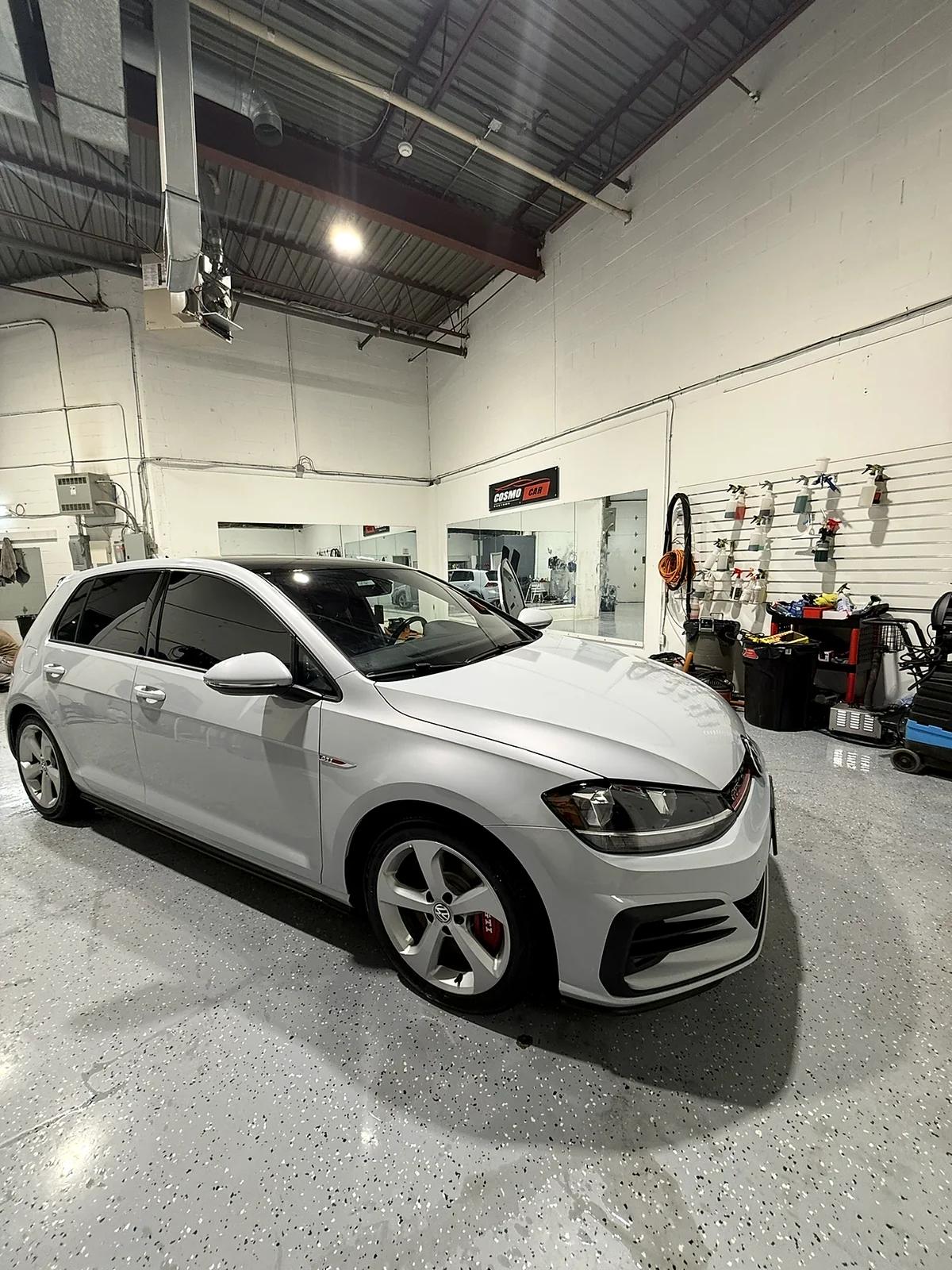 White Volkswagen Golf GTI detailed in the Cosmo Car Customs studio