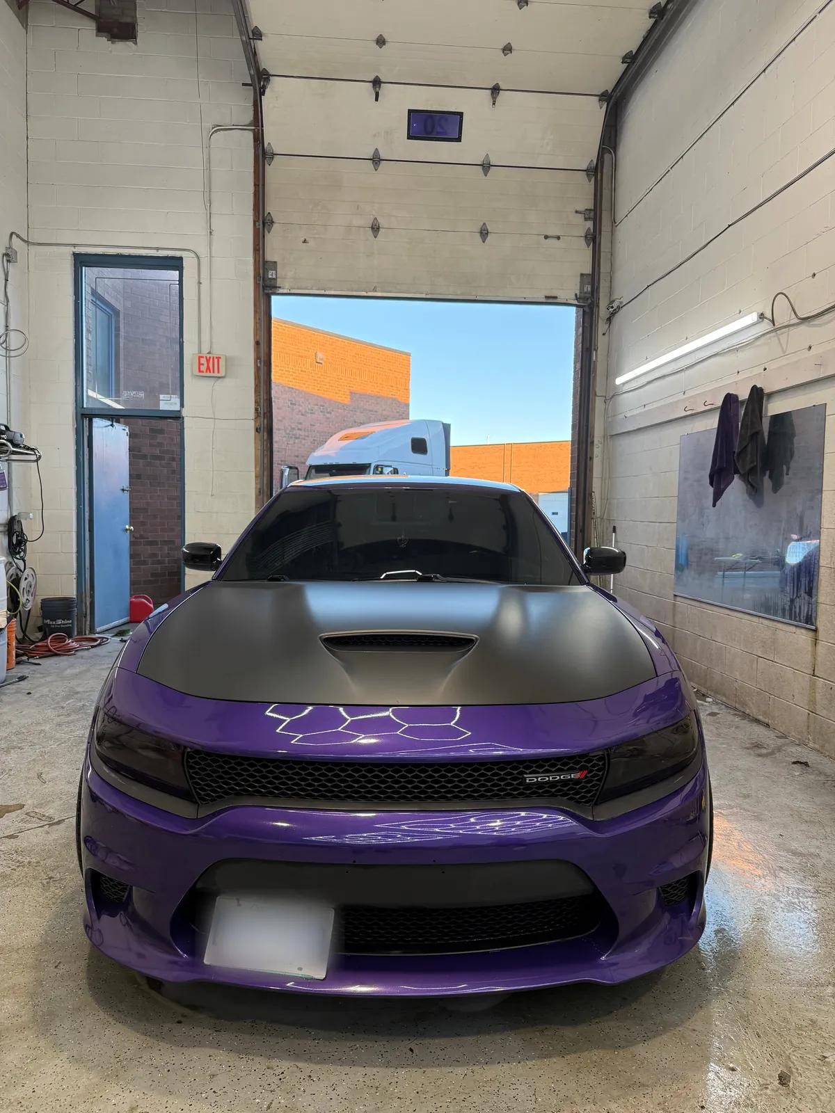 Purple Dodge Charger with a matte black hood after a detail in the Mississauga studio