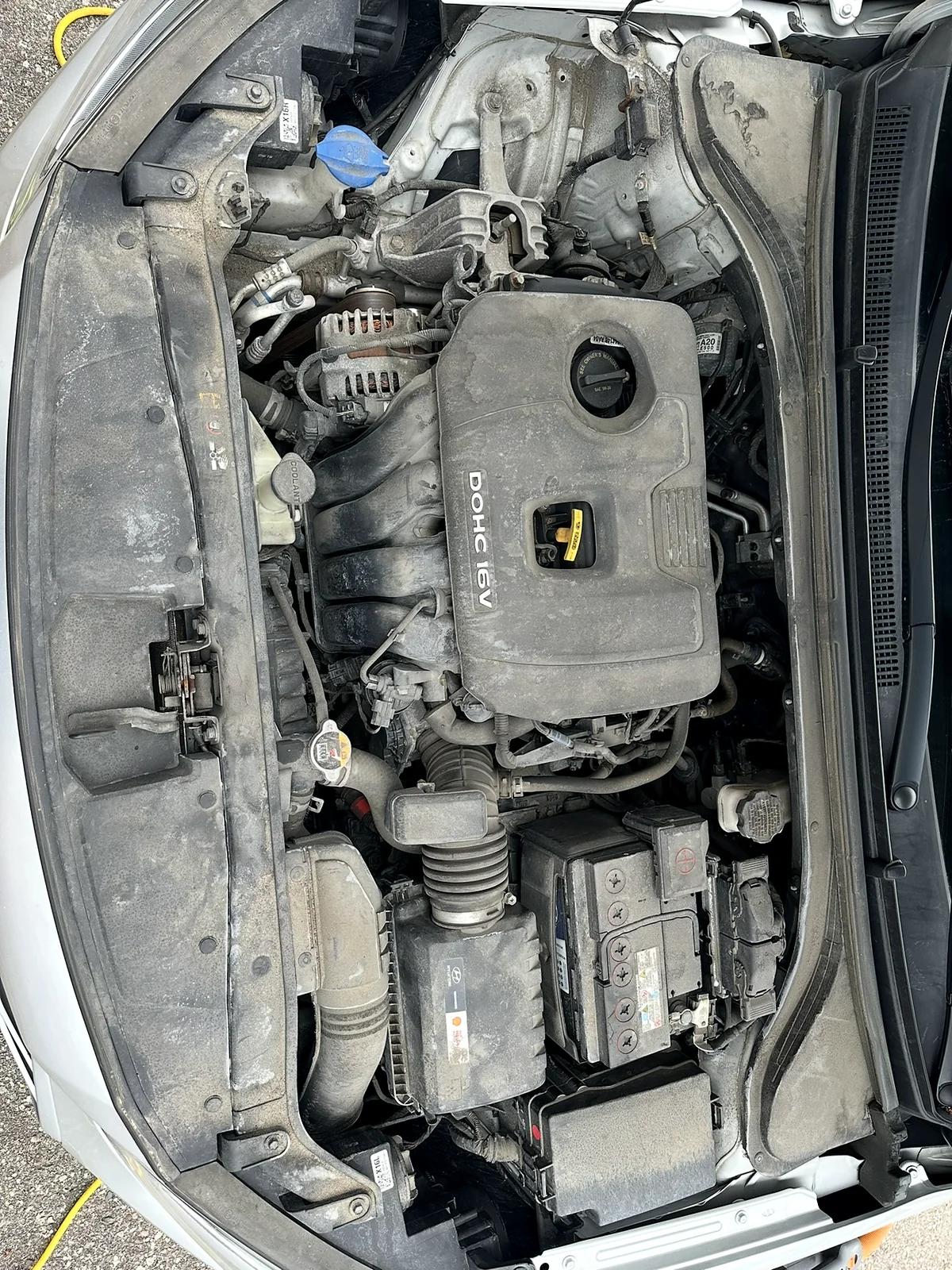 Dusty engine bay before an engine bay detail