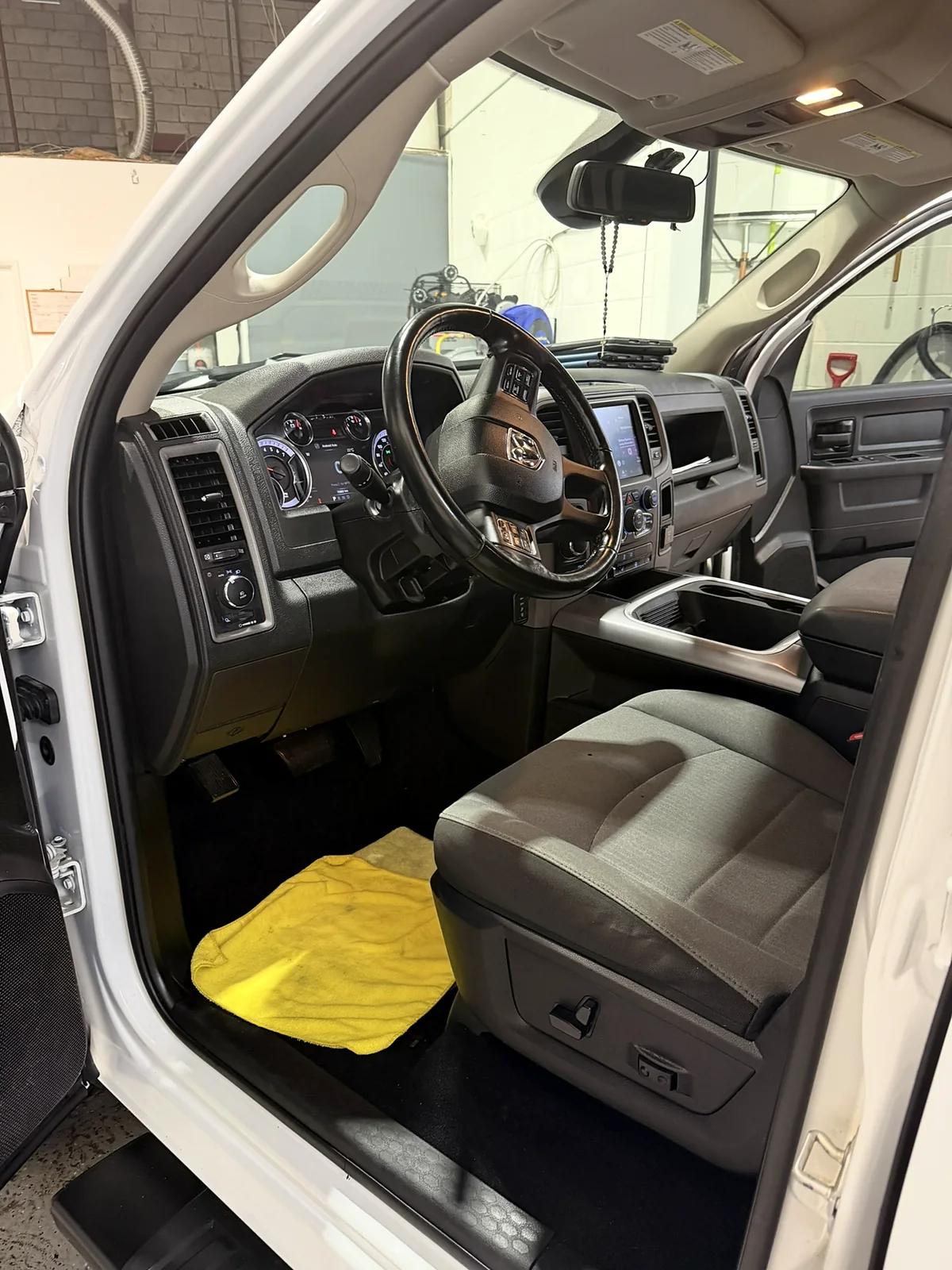 The same Ram pickup footwell and seat after an interior detail