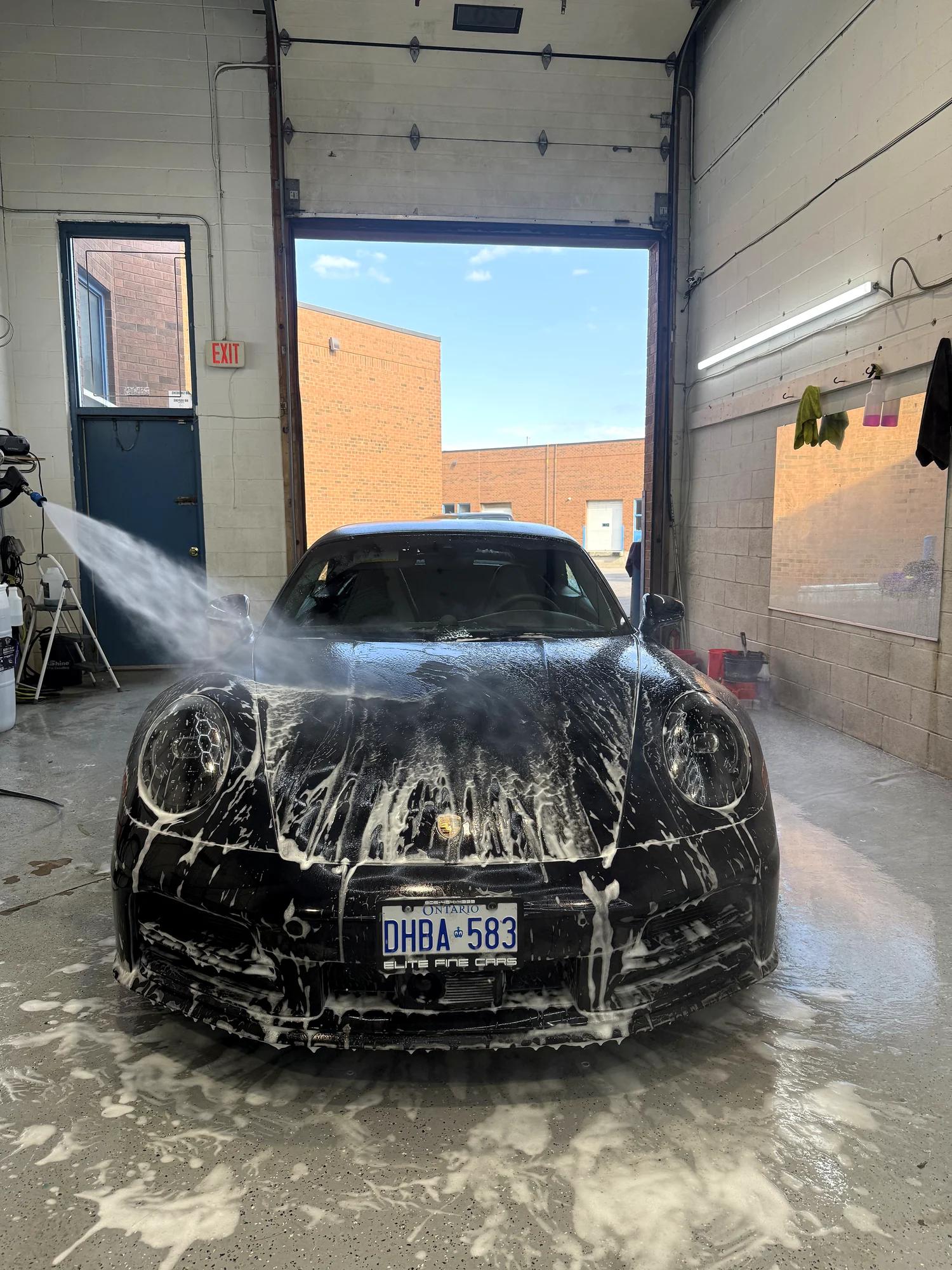 Lexus IS covered in snow foam during the wash before film installation