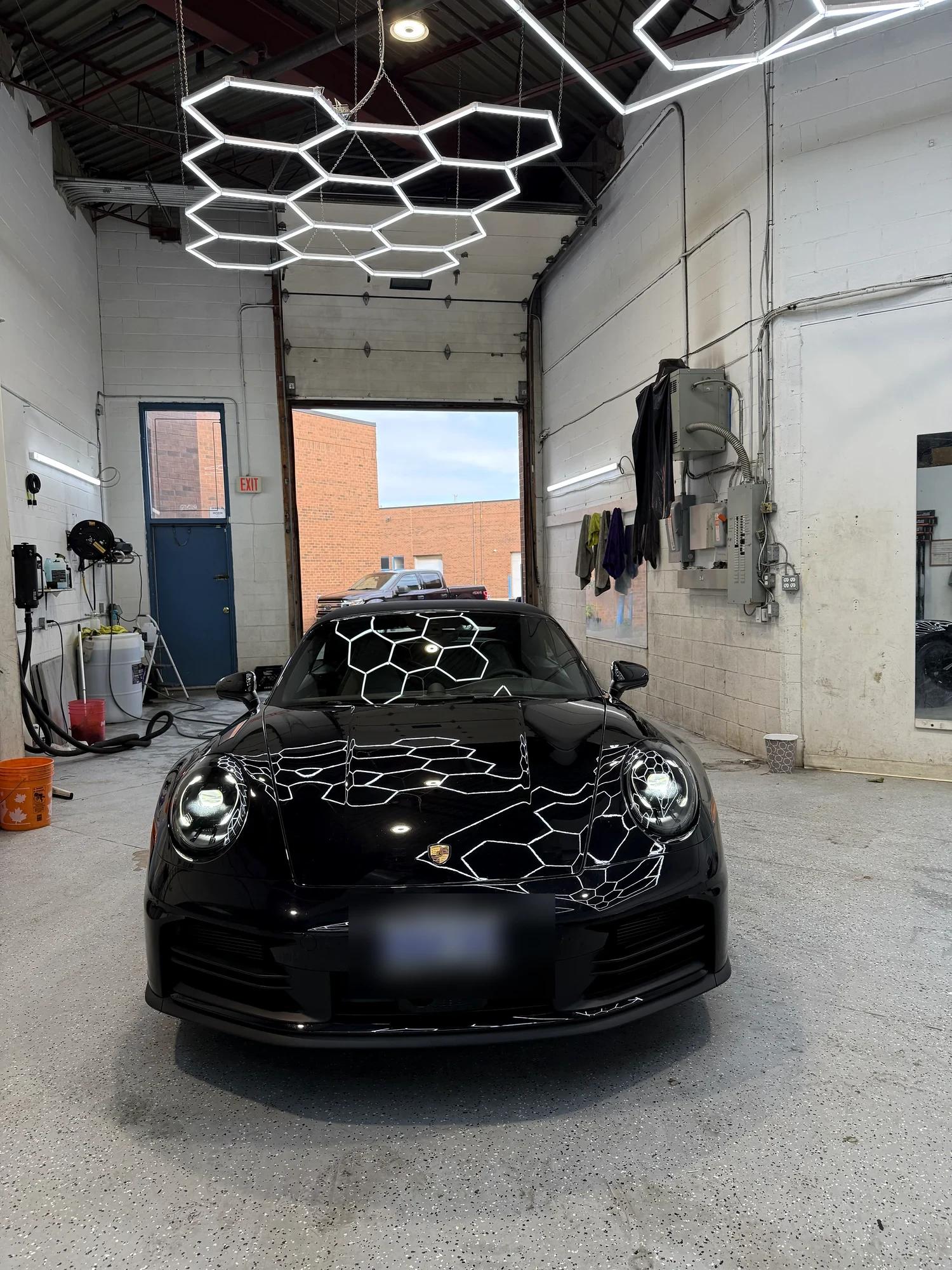 The finished Porsche 911 under the studio hex lights