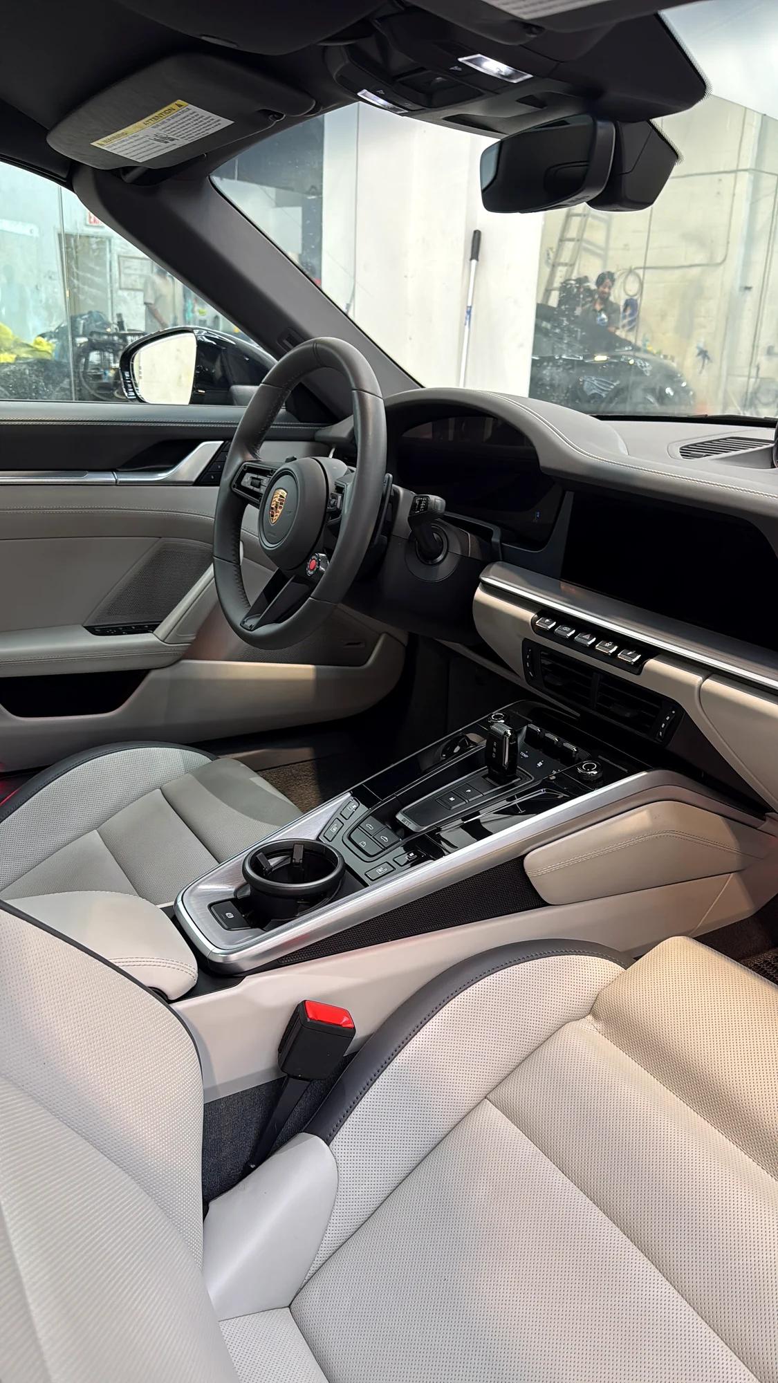 Detailed light leather interior and dashboard of the Porsche 911