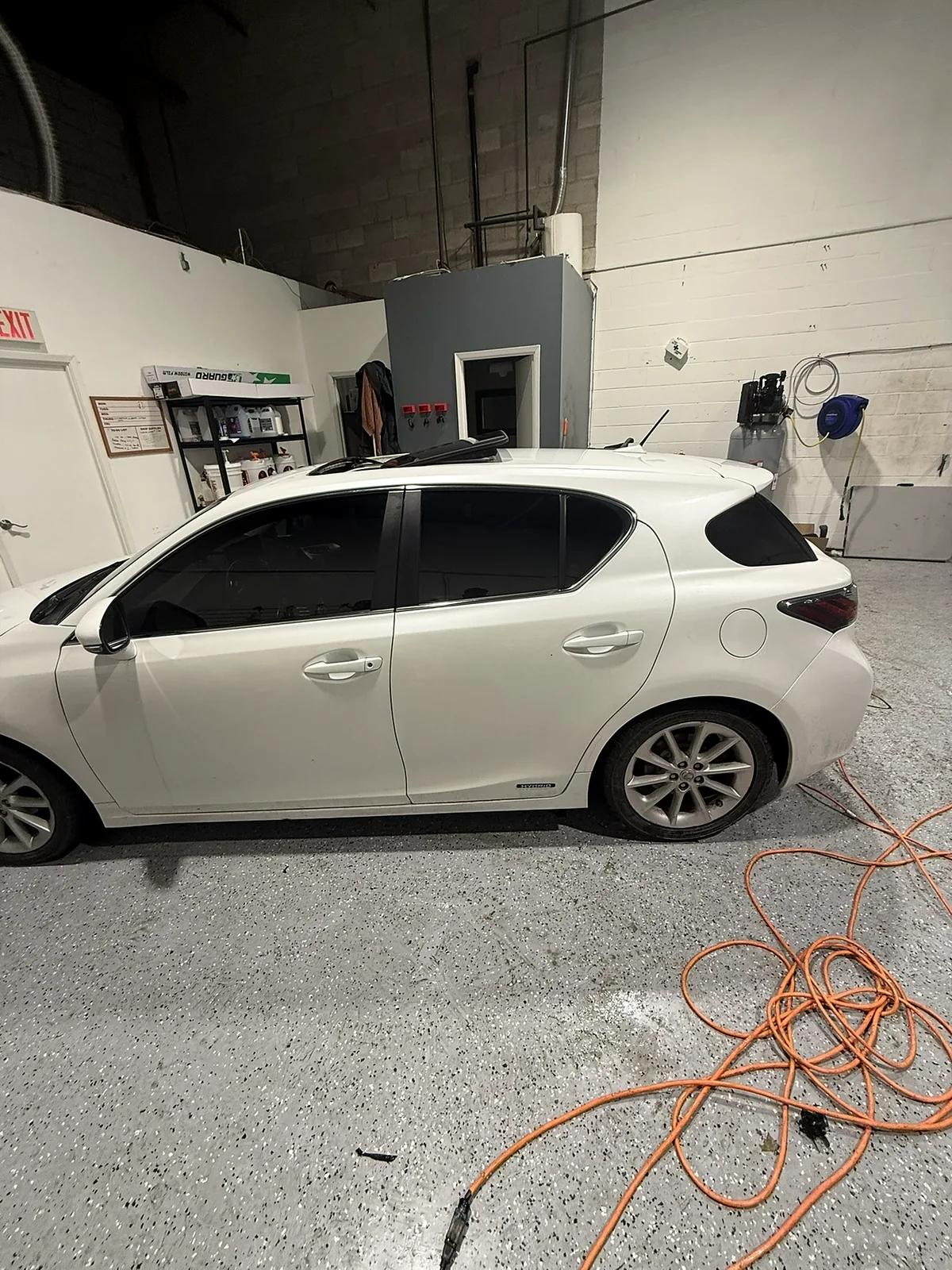 White Lexus CT with tinted windows in the studio