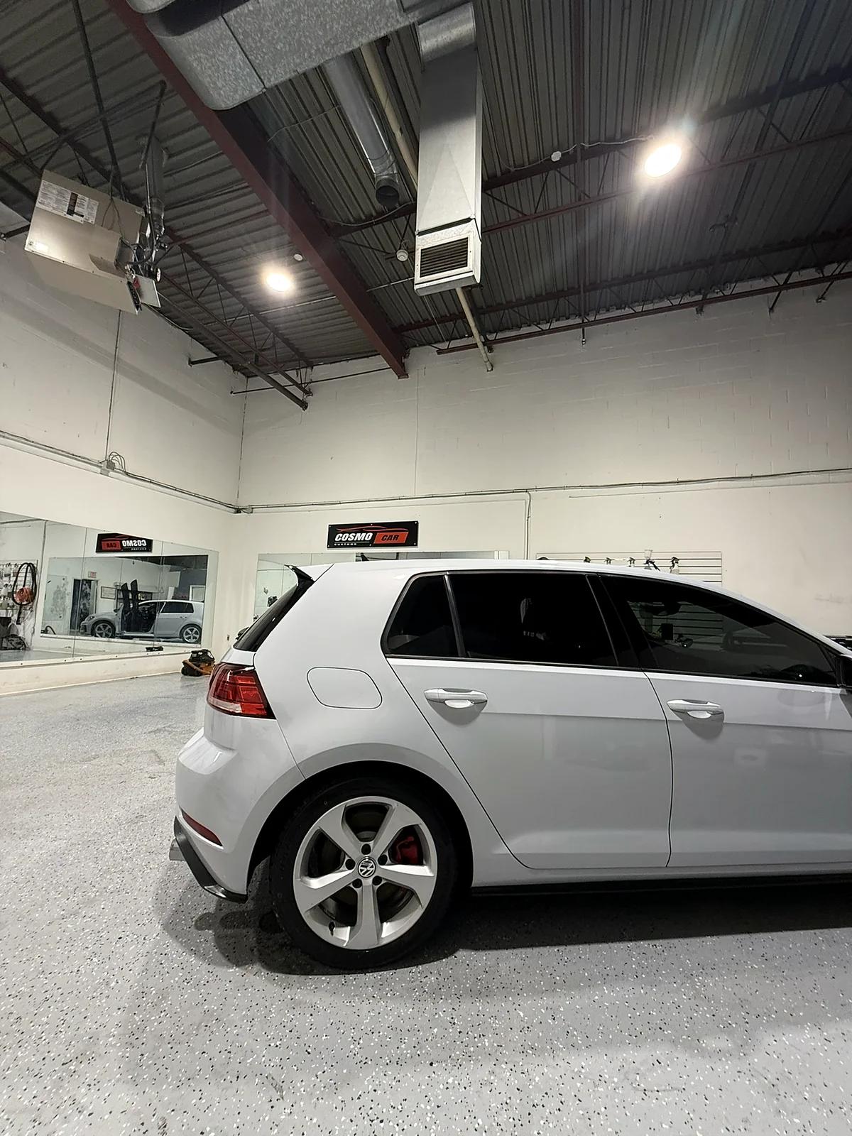 White Volkswagen Golf with tinted rear and side windows