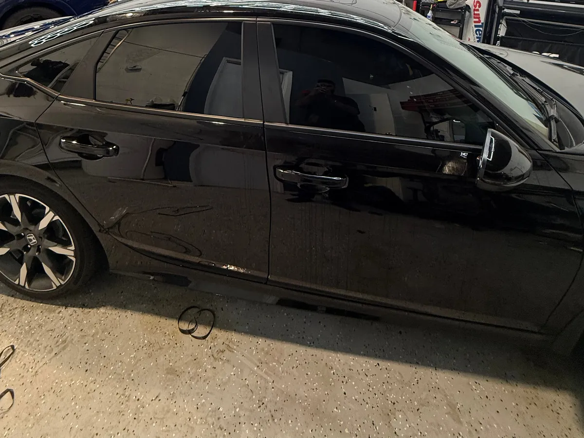 Black Honda Civic with tinted side windows in the Mississauga studio