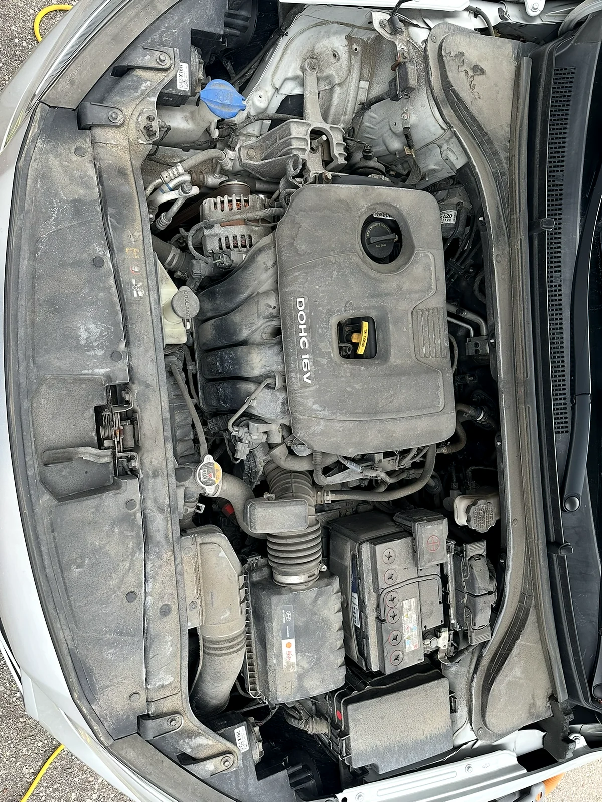 Dusty engine bay before an engine bay detail